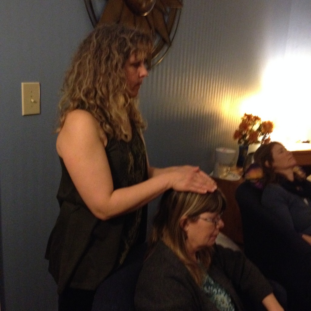 Terrie providing Reiki while Kate sounds the bowls.