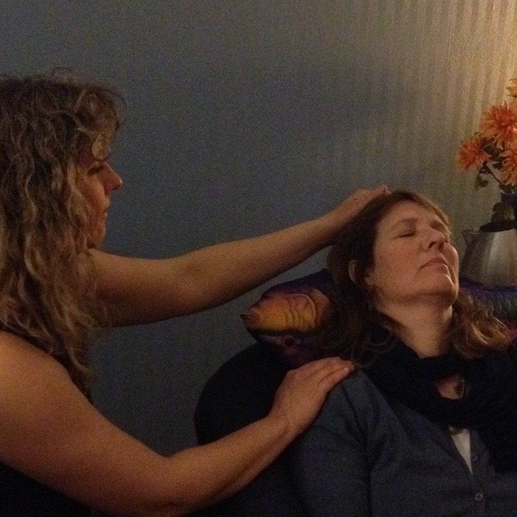 Terrie providing Reiki to a very relaxed participant!